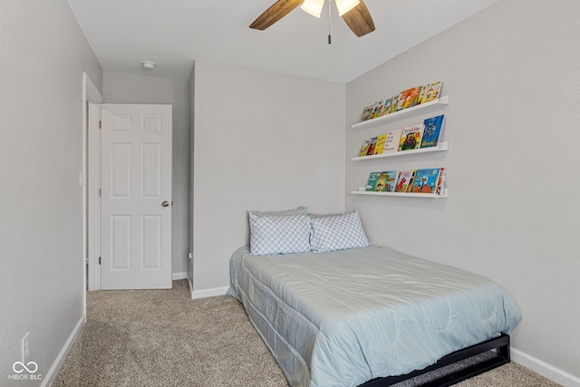 bedroom with a ceiling fan, baseboards, and carpet