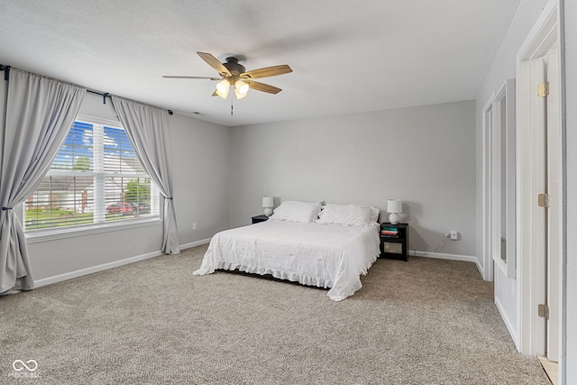 bedroom featuring baseboards, a ceiling fan, and carpet flooring