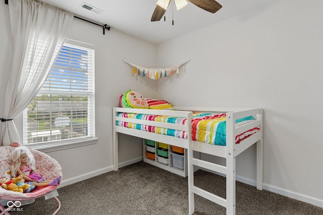 carpeted bedroom featuring a ceiling fan, baseboards, and visible vents