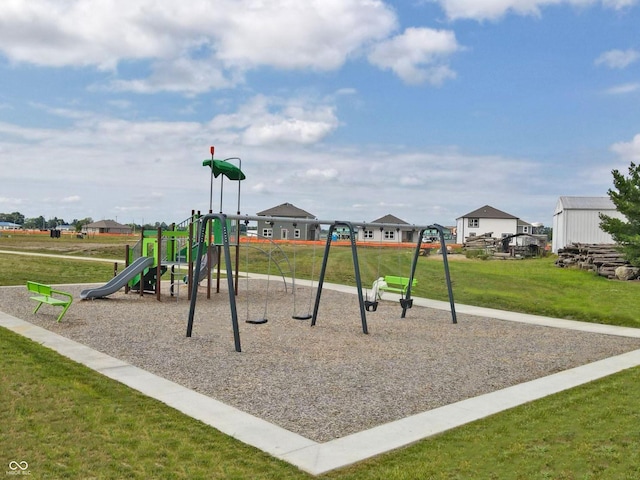 community play area featuring a lawn and a residential view