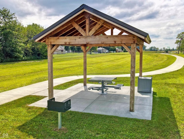 view of property's community featuring a gazebo, a lawn, and a patio area