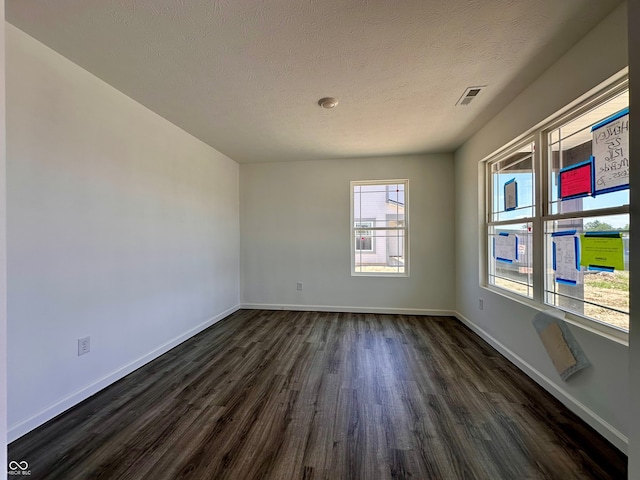 1216 Mcbride St, Greenfield, IN 46140 - empty room with dark wood finished floors, baseboards, and a textured ceiling