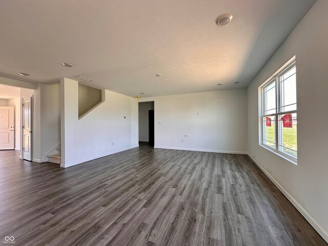 1216 Mcbride St, Greenfield, IN 46140 - spare room featuring dark wood-style floors, baseboards, and a textured ceiling