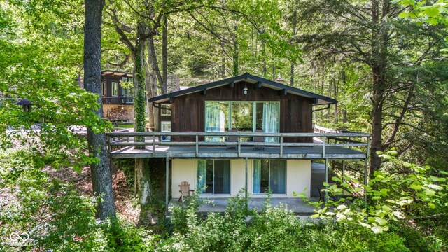 1686 Borders Rd, Nashville, IN 47448 - view of front of home featuring a wooded view, a deck, and a patio area