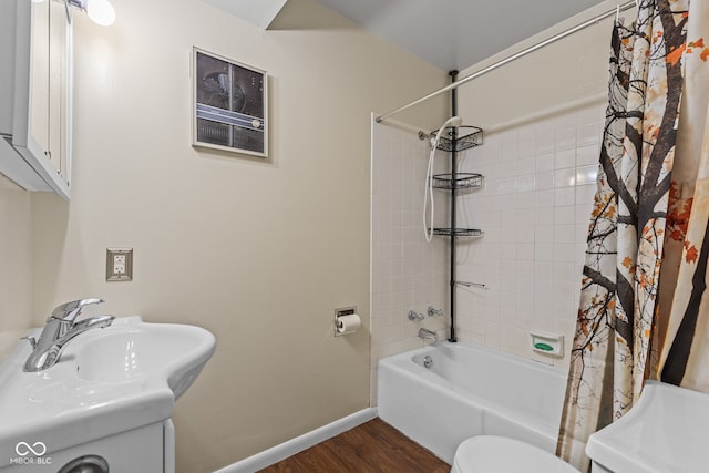 1686 Borders Rd, Nashville, IN 47448 - bathroom featuring wood finished floors, baseboards, toilet, shower / bath combination with curtain, and a sink