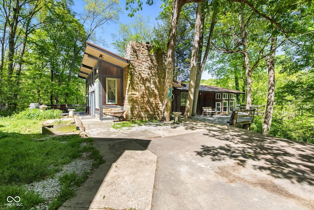 1686 Borders Rd, Nashville, IN 47448 - rear view of property featuring a chimney and a patio