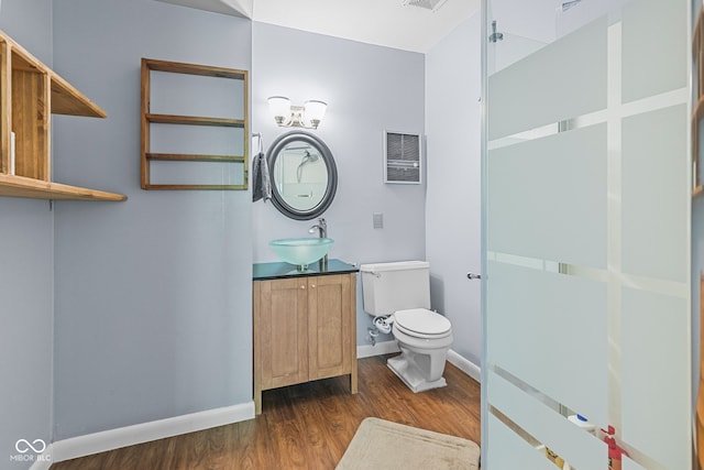 1686 Borders Rd, Nashville, IN 47448 - bathroom featuring wood finished floors, toilet, baseboards, vanity, and a chandelier