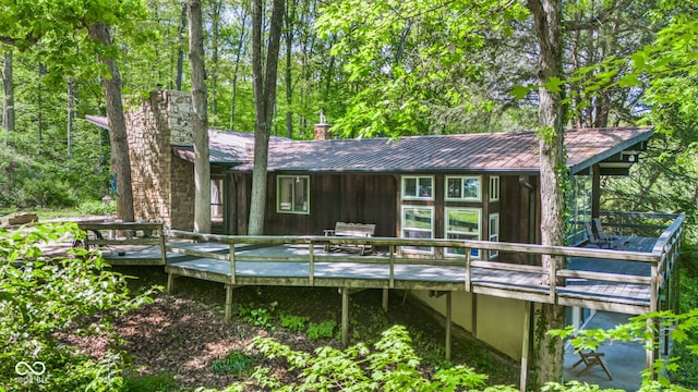 1686 Borders Rd, Nashville, IN 47448 - back of house with a chimney, metal roof, and a wooden deck