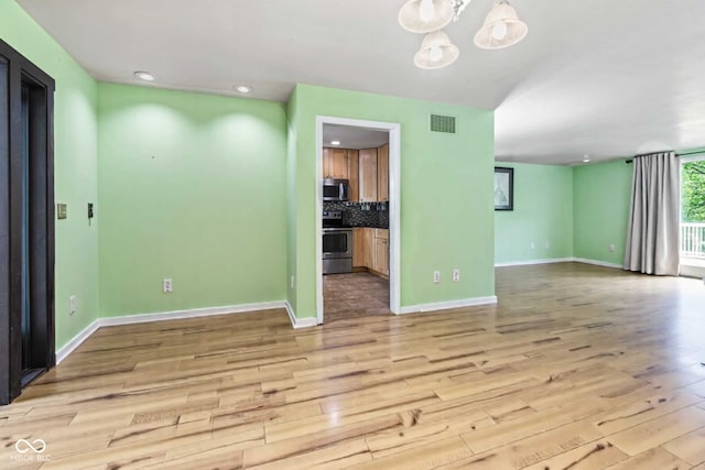 1686 Borders Rd, Nashville, IN 47448 - unfurnished living room with light wood-style floors, baseboards, a chandelier, and recessed lighting