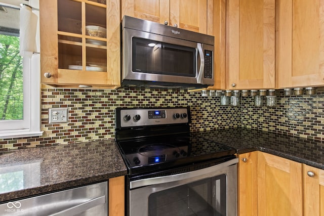 1686 Borders Rd, Nashville, IN 47448 - kitchen with appliances with stainless steel finishes, backsplash, glass insert cabinets, and dark stone counters