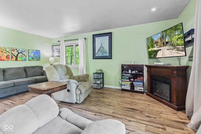 1686 Borders Rd, Nashville, IN 47448 - living room featuring baseboards, a glass covered fireplace, wood finished floors, and recessed lighting