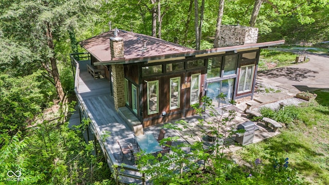1686 Borders Rd, Nashville, IN 47448 - view of front of house featuring a chimney and a deck