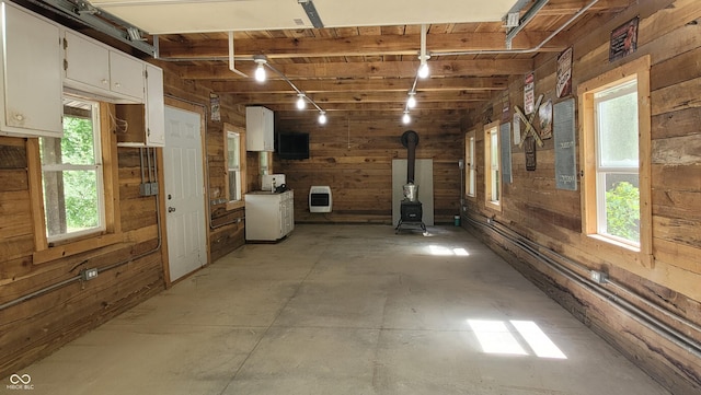 1686 Borders Rd, Nashville, IN 47448 - interior space featuring wooden walls, a wood stove, and heating unit