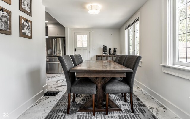 5124 N Capitol Ave, Indianapolis, IN 46208 - dining space with baseboards, plenty of natural light, and marble finish floor