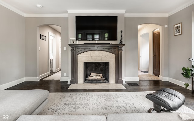 5124 N Capitol Ave, Indianapolis, IN 46208 - living room featuring crown molding, arched walkways, baseboards, and wood finished floors