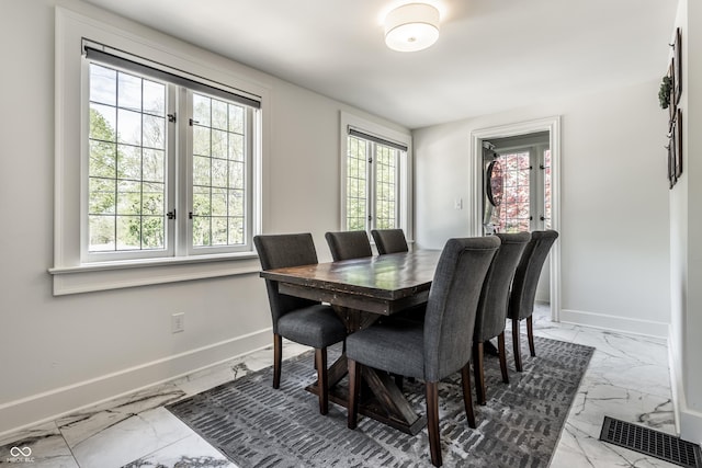 5124 N Capitol Ave, Indianapolis, IN 46208 - dining room with plenty of natural light, marble finish floor, baseboards, and visible vents
