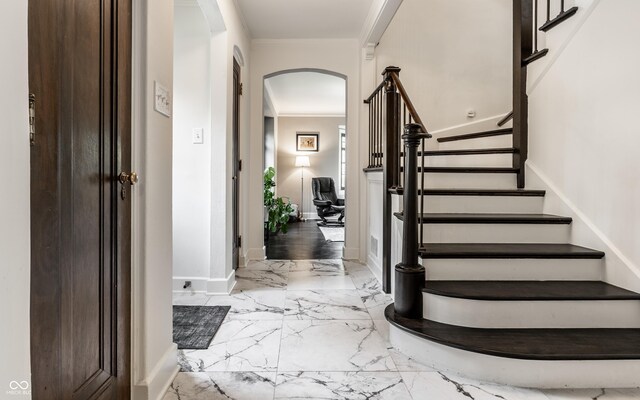 5124 N Capitol Ave, Indianapolis, IN 46208 - entryway with arched walkways, marble finish floor, stairs, baseboards, and ornamental molding