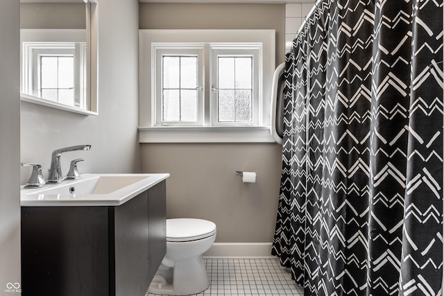 5124 N Capitol Ave, Indianapolis, IN 46208 - bathroom with toilet, tile patterned floors, a healthy amount of sunlight, and vanity