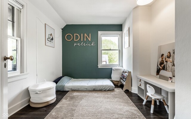 5124 N Capitol Ave, Indianapolis, IN 46208 - bedroom with baseboards, dark wood-style flooring, and vaulted ceiling