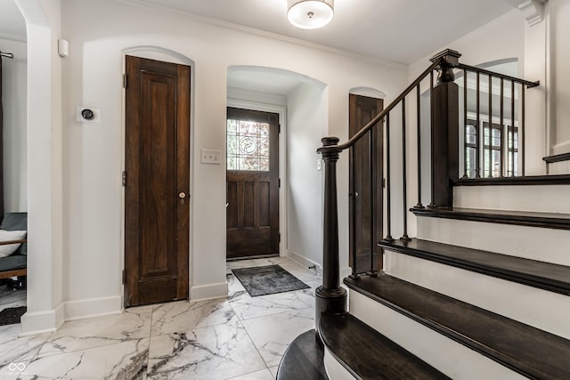 5124 N Capitol Ave, Indianapolis, IN 46208 - foyer entrance featuring stairway, arched walkways, ornamental molding, and marble finish floor