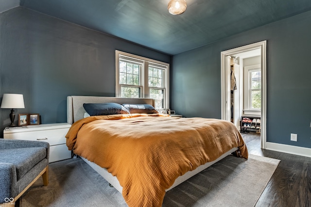 5124 N Capitol Ave, Indianapolis, IN 46208 - bedroom with baseboards, multiple windows, and dark wood finished floors