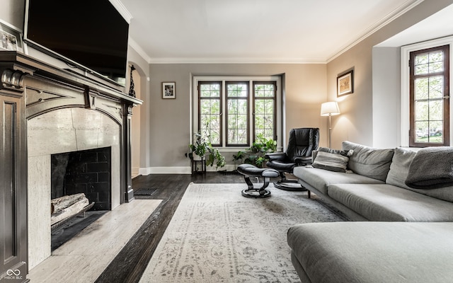 5124 N Capitol Ave, Indianapolis, IN 46208 - living room with crown molding, baseboards, wood finished floors, and a tiled fireplace