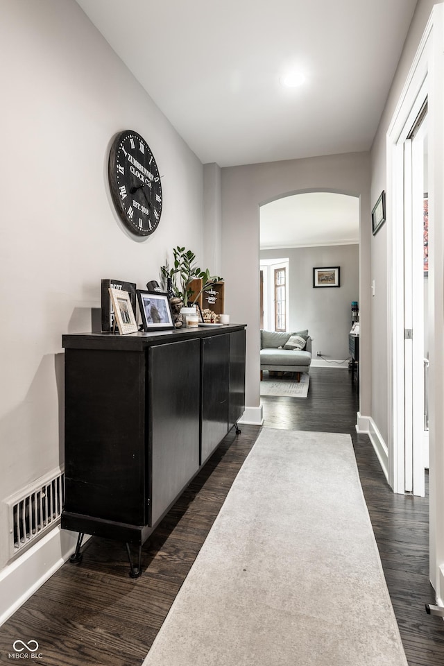 5124 N Capitol Ave, Indianapolis, IN 46208 - corridor with arched walkways, baseboards, visible vents, and dark wood-type flooring