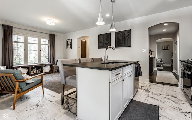 5124 N Capitol Ave, Indianapolis, IN 46208 - kitchen with a kitchen bar, arched walkways, a sink, marble finish floor, and recessed lighting