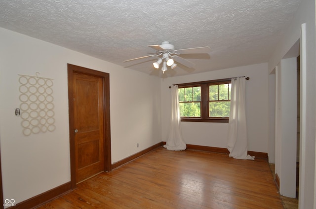 6051 Lowell Ave, Indianapolis, IN 46219 - empty room with light wood-style flooring, ceiling fan, and a textured ceiling