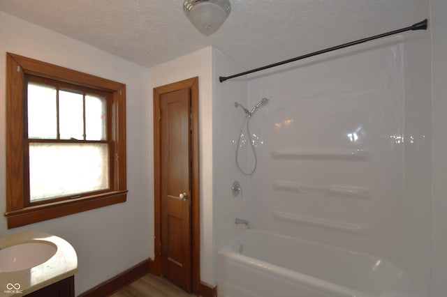 6051 Lowell Ave, Indianapolis, IN 46219 - bathroom with vanity, a textured ceiling, and shower / bathtub combination