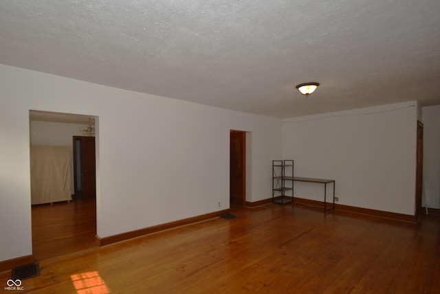 6051 Lowell Ave, Indianapolis, IN 46219 - unfurnished room featuring wood finished floors and a textured ceiling