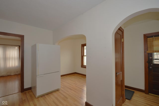 6051 Lowell Ave, Indianapolis, IN 46219 - unfurnished room with light wood-style floors and arched walkways