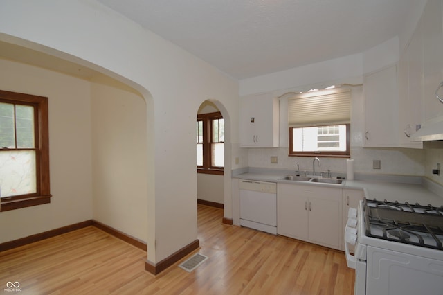 6051 Lowell Ave, Indianapolis, IN 46219 - kitchen featuring white appliances, light countertops, light wood-type flooring, backsplash, and white cabinets