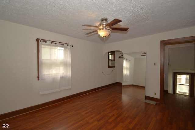 6051 Lowell Ave, Indianapolis, IN 46219 - unfurnished room featuring wood finished floors, ceiling fan, a textured ceiling, and arched walkways