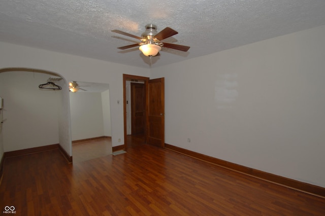 6051 Lowell Ave, Indianapolis, IN 46219 - empty room with a ceiling fan, wood finished floors, and a textured ceiling