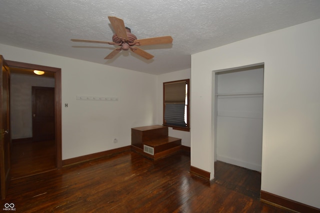 6051 Lowell Ave, Indianapolis, IN 46219 - unfurnished bedroom with a textured ceiling, wood-type flooring, a closet, and a ceiling fan