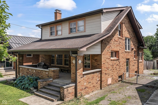 6051 Lowell Ave, Indianapolis, IN 46219 - rear view of house featuring an outdoor kitchen, a chimney, brick siding, roof with shingles, and a patio area