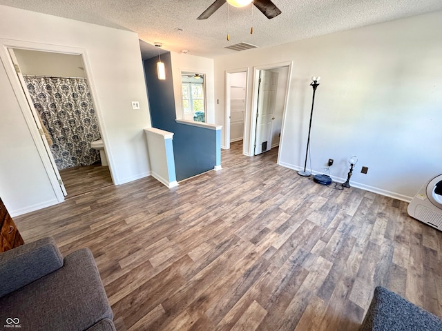 4223 Kestrel Ct, Indianapolis, IN 46254 - unfurnished living room featuring a textured ceiling, a ceiling fan, wood finished floors, and visible vents