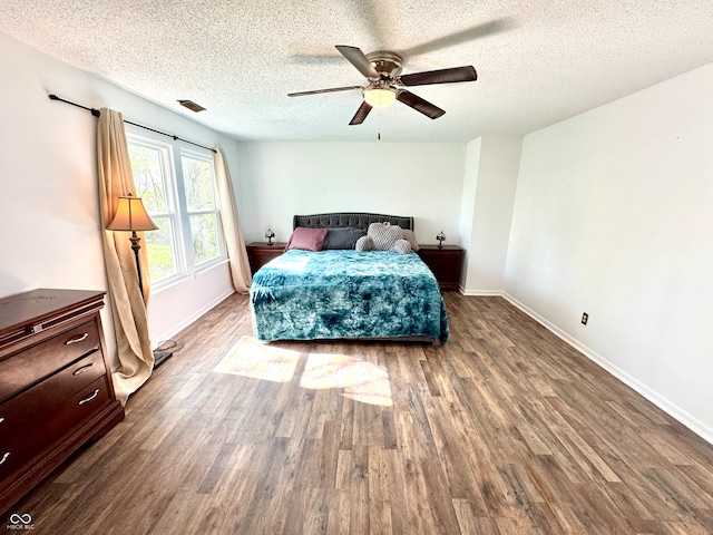 4223 Kestrel Ct, Indianapolis, IN 46254 - bedroom featuring baseboards, a textured ceiling, visible vents, and wood finished floors