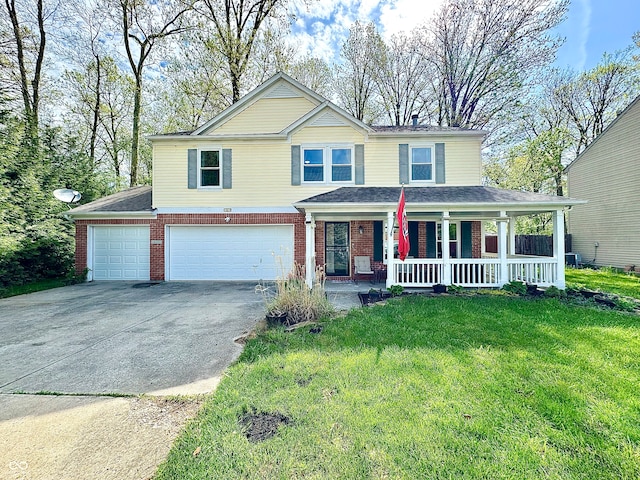 4223 Kestrel Ct, Indianapolis, IN 46254 - traditional home featuring covered porch, a front yard, a garage, brick siding, and concrete driveway
