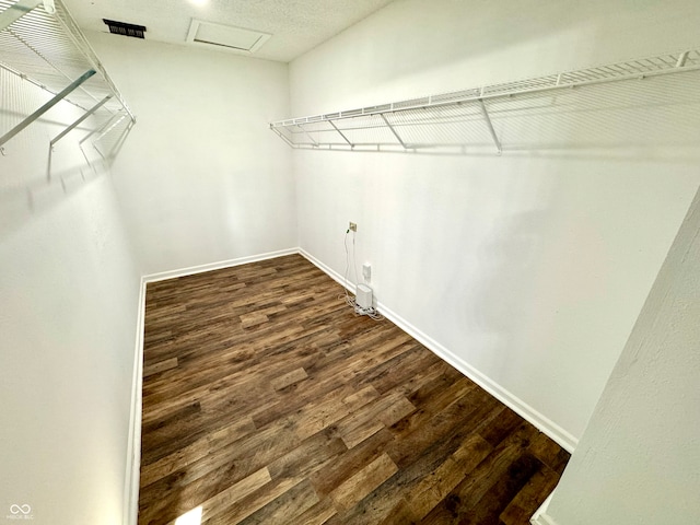 4223 Kestrel Ct, Indianapolis, IN 46254 - walk in closet featuring dark wood-style floors and attic access