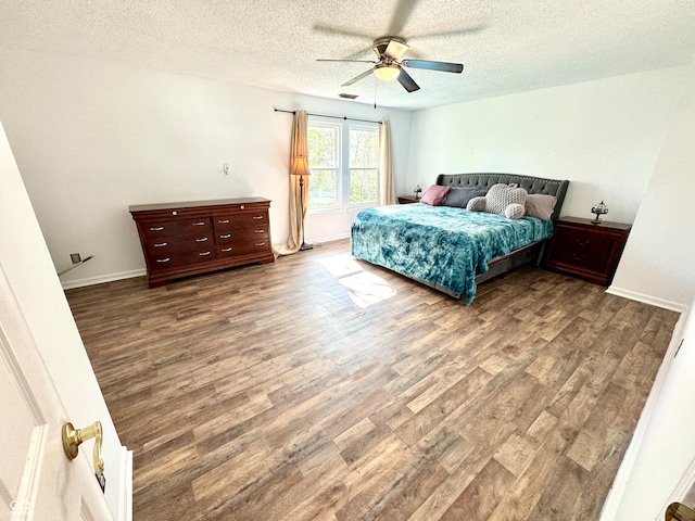 4223 Kestrel Ct, Indianapolis, IN 46254 - bedroom featuring baseboards, a ceiling fan, a textured ceiling, and wood finished floors