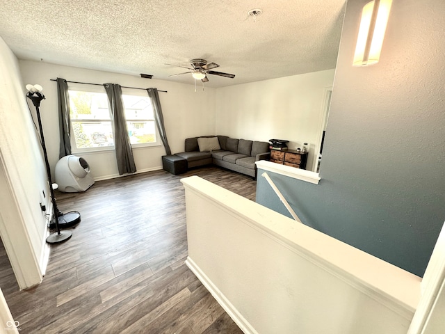 4223 Kestrel Ct, Indianapolis, IN 46254 - living area with a textured ceiling, baseboards, a ceiling fan, and wood finished floors