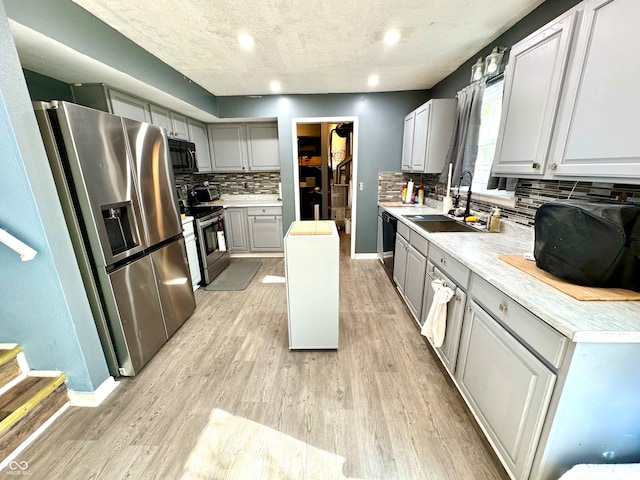 4223 Kestrel Ct, Indianapolis, IN 46254 - kitchen featuring gray cabinetry, a sink, black appliances, and light wood-style floors
