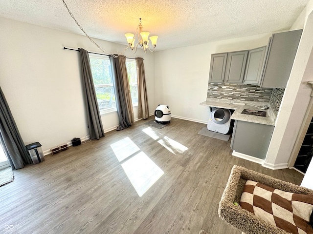 4223 Kestrel Ct, Indianapolis, IN 46254 - unfurnished dining area with baseboards, light wood finished floors, a textured ceiling, and a chandelier
