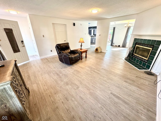 4223 Kestrel Ct, Indianapolis, IN 46254 - living area with baseboards, light wood-type flooring, and a textured ceiling