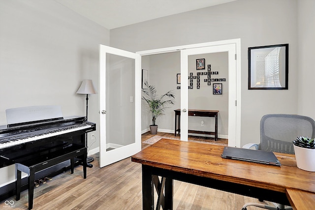 office area featuring baseboards, french doors, and wood finished floors