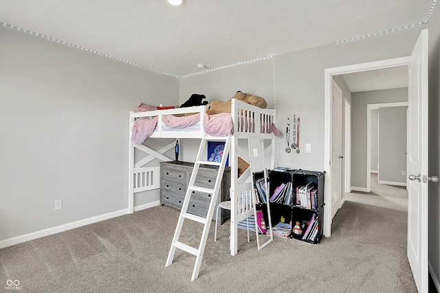 carpeted bedroom featuring baseboards