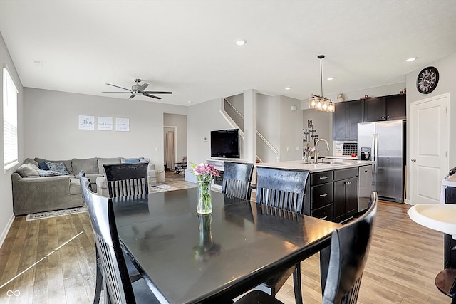 dining space featuring a ceiling fan, baseboards, recessed lighting, and light wood-style floors