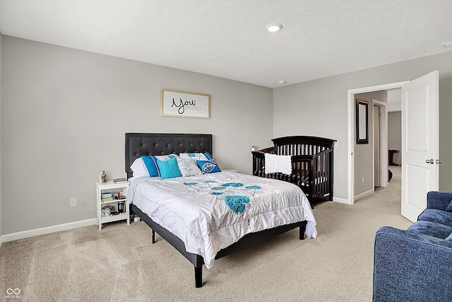 bedroom with light colored carpet and baseboards